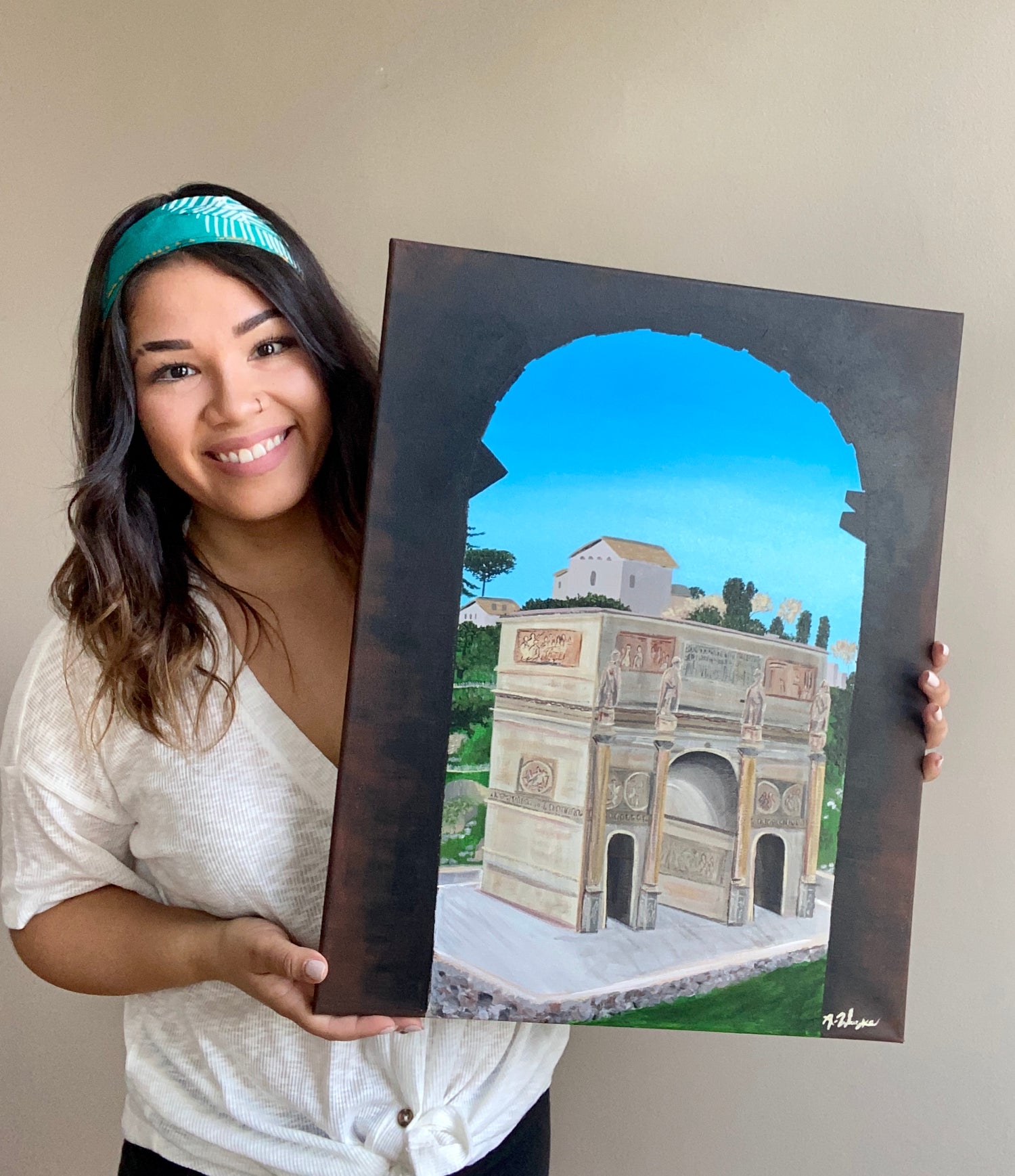Travel Artist from Boston, Ma holds up an original commissioned painting.