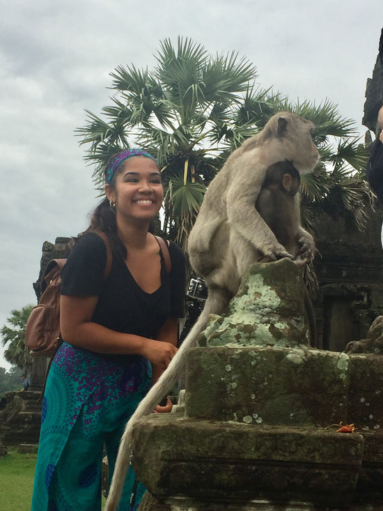 Boston Travel Artist Alexandra Wuyke standing next to a monkey.